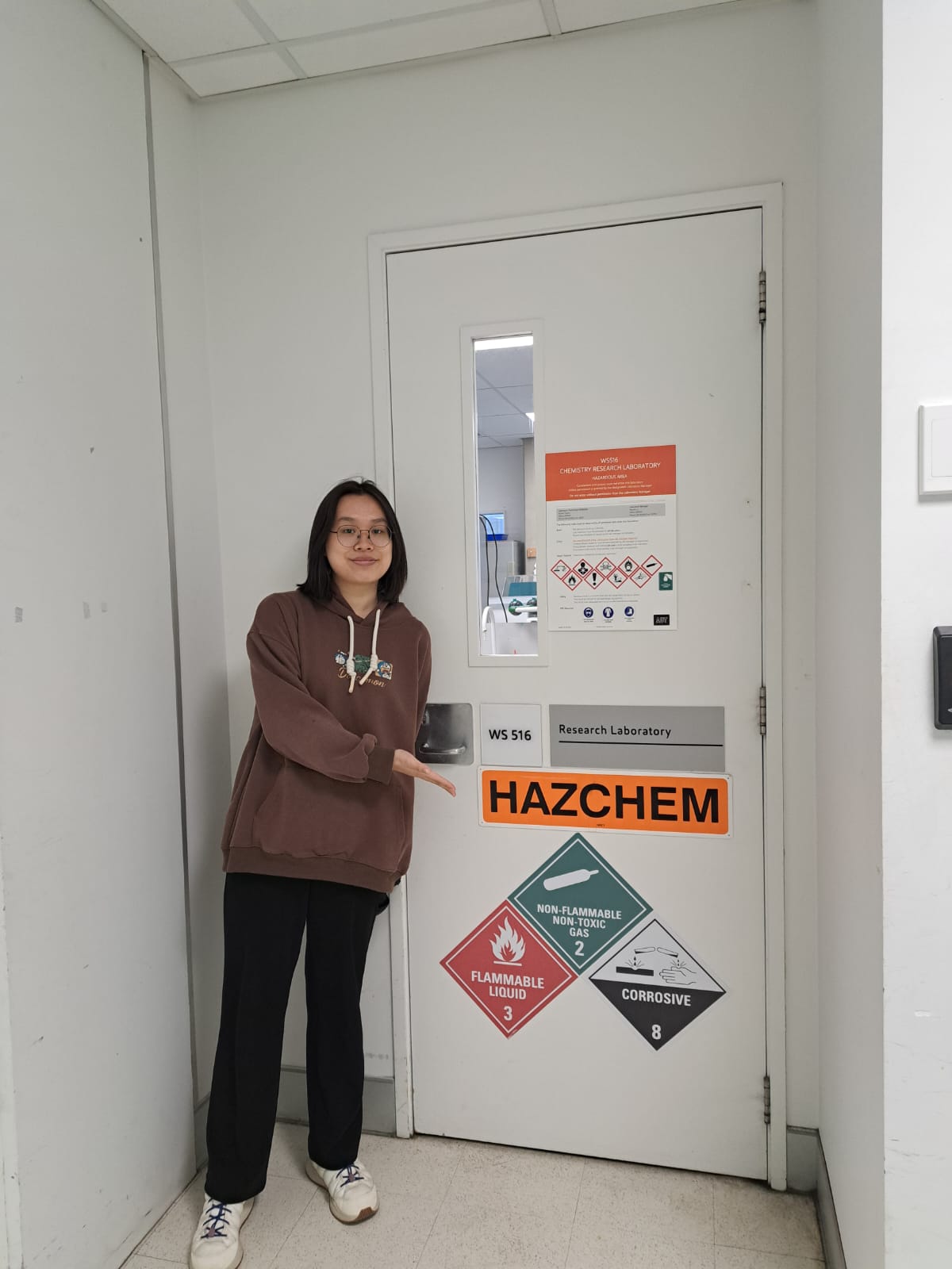 Alumna outside the chemistry research laboratory at her host university